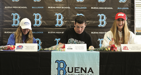 Grace Saad, Trevor Smentek and Marissa Saucedo sign their scholarship documents on Feb 5, 2020 at the Buena High School Library in front of faculty, family and friends. 