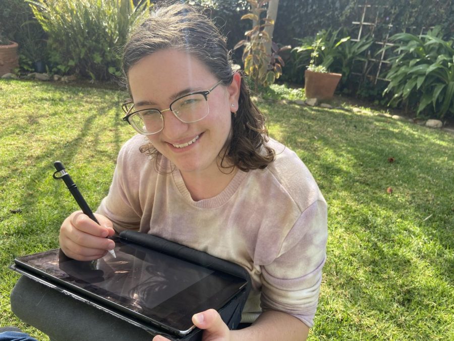Photo of Hope Stewart drawing on her iPad Pro (12.9 inches) outside on a bright sunny day. 