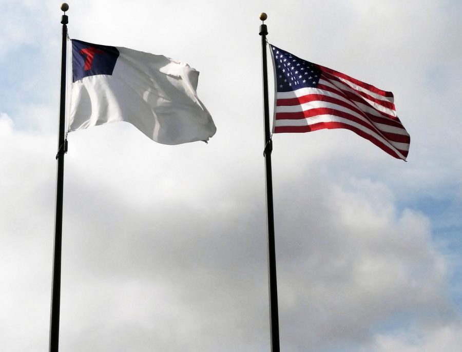 The Christian flag flying next to the American flag, symbolizing the religious freedoms in America.