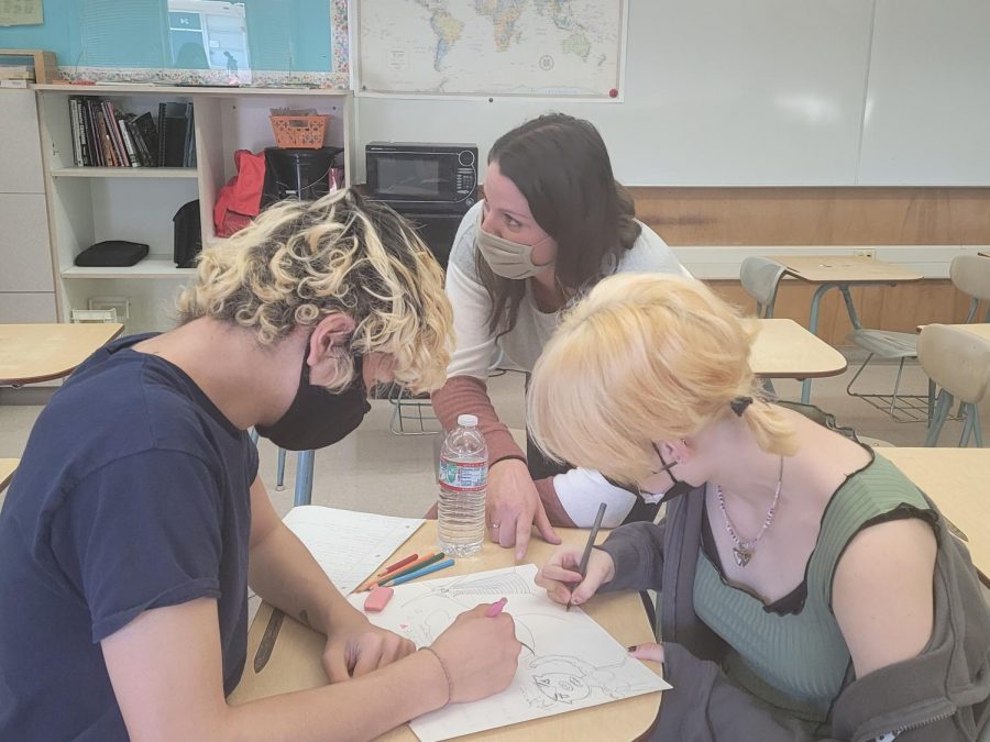 Mrs. McCown helping students Iman Zuhric (left) and James Berg (right) 