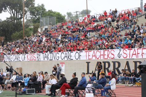 Teachers filling the stands of the Annual Celebrate event, with their banner that reads take care of kids by taking care of teachers and staff