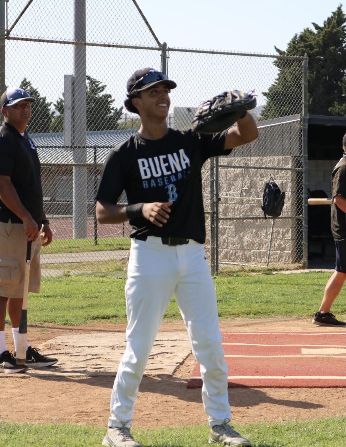 Sophomore varsity starter Elijah Garcia warms up for his upcoming pre season games to be Buena High Schools catcher. 