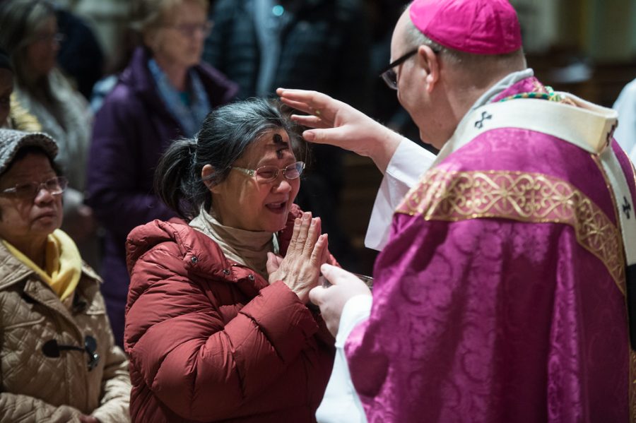 A woman receiving her ashes during Ash Wednesday Mass at St. Georges Cathedral