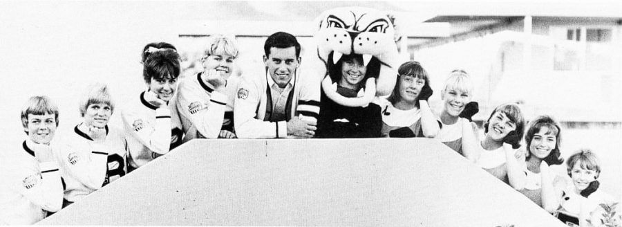 “Kathie Masterson, Cindy Sorensen, Syd Thibedeau, Betty Stone, Russ Kloer, Terry Wolever, Cindie Truesdell, Tisha Hatcher, Marcia Newlon.” Shows the Spike mascot headpiece. 