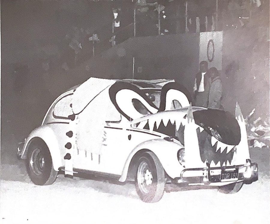 “BITING BUG – down the track Spike chased a Volkswagen Kitty.” Cars were often dressed up in school spirit for rival games. 