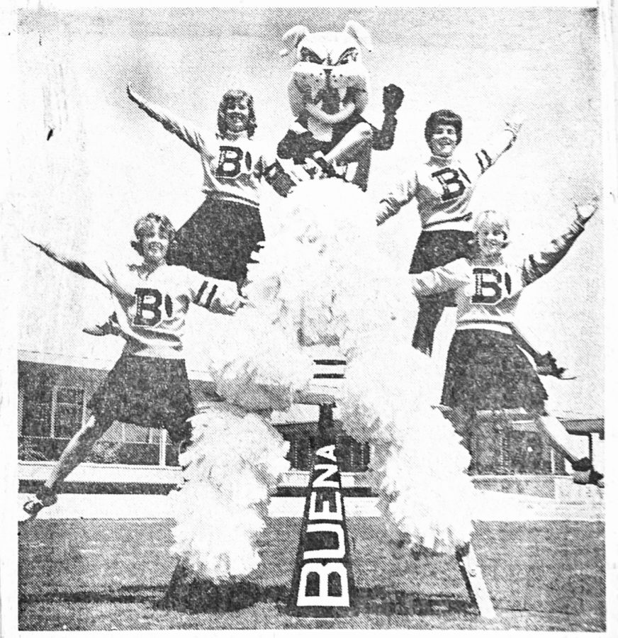 “BUENA CHEERLEADERS-Striking this interesting pose are the five girls charged with leading the Buena High School cheering section this year, Clockwise from the lower left, are Susan Bradford, Clare Stevens, Jan McCormick, Kathy McKinney, and Heather Banks. All except Jan, who is Spike the Bulldog, were on Buena’s first cheerleading squad last year.” This shows the 1963 varsity cheer-leading team, which Spike was often included in because of the simple head piece.