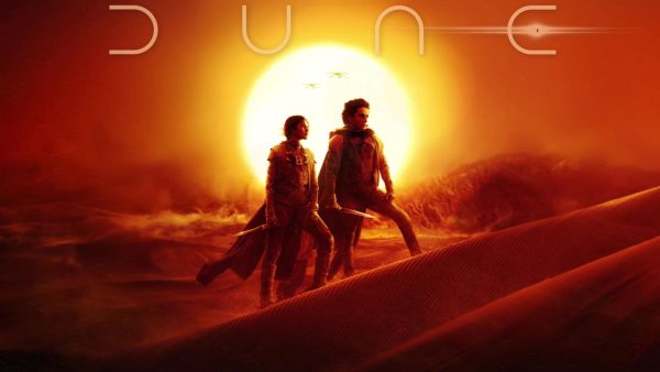 Image of Paul Atreides (Timothee Chalamet )and Chani (Zendaya) looking over the dunes of Arrakis.