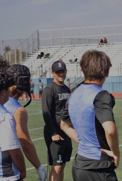 The head football coach and new athletic director Bolland with his athletes. 