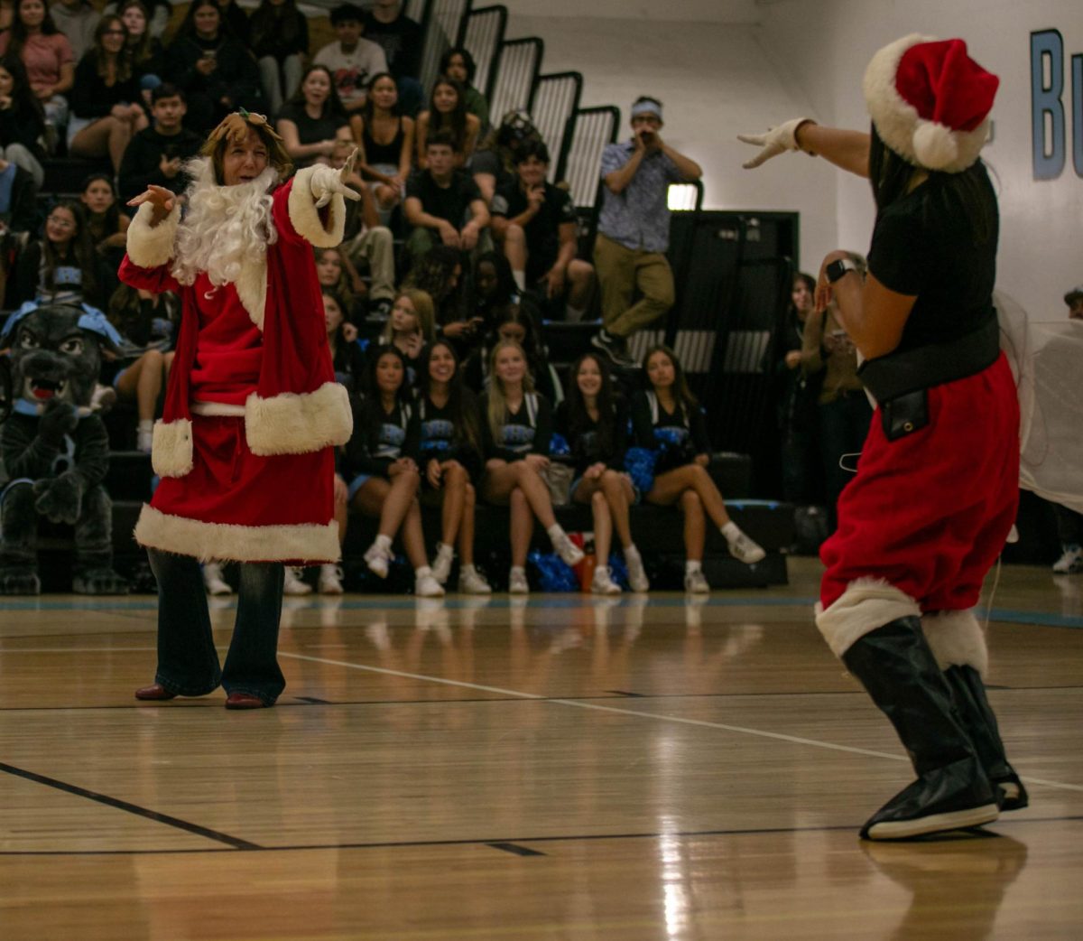 Giving each other a friendly salute, the twinning Santa's, teachers Antoinette Perez and Teresa Hayes, compete to win the teacher dress up game.