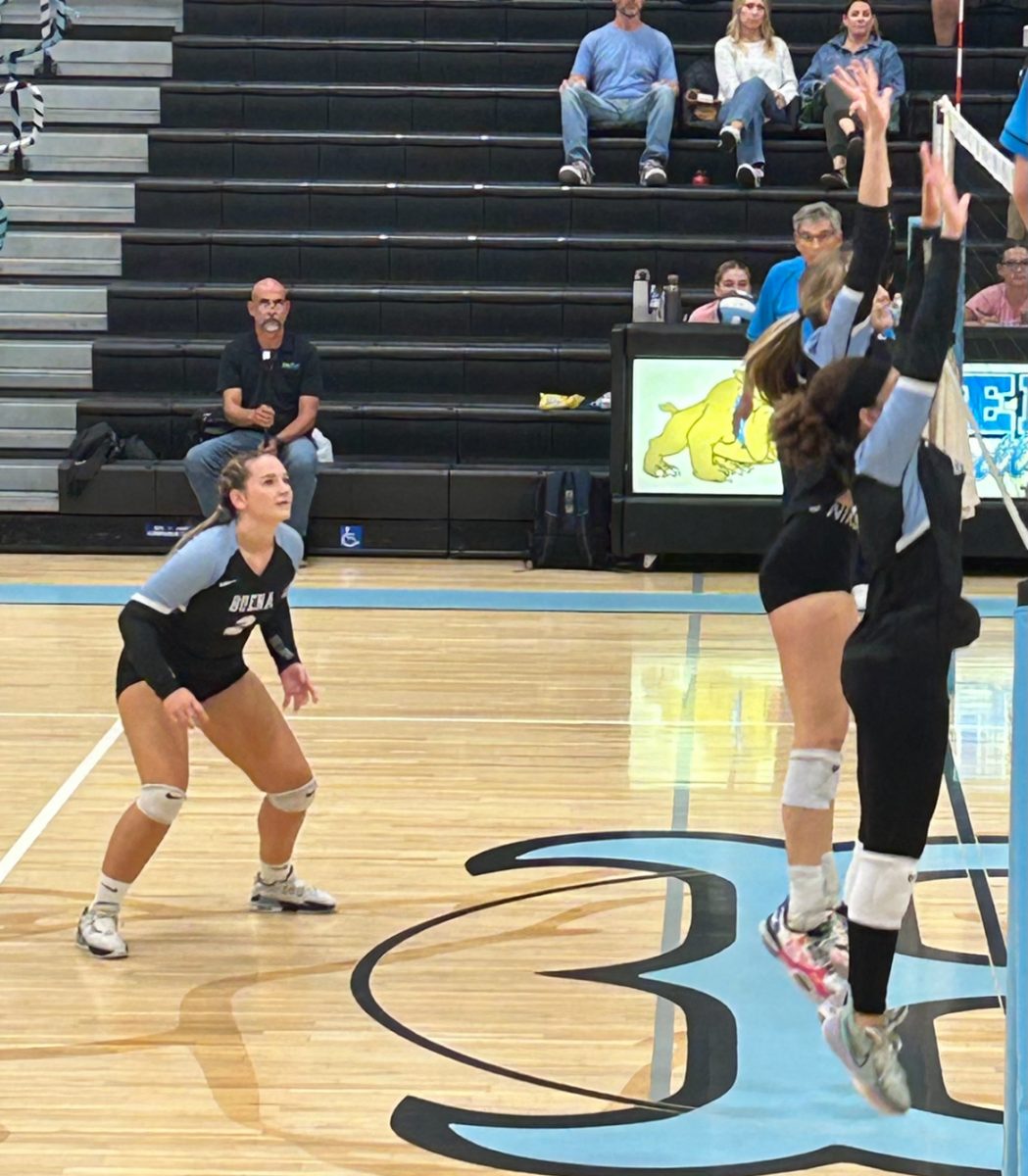 Kenna Wilson and Mimi Moon go up for the block, Kayla Templin prepares to receive the spike in exciting third set against SBHS.