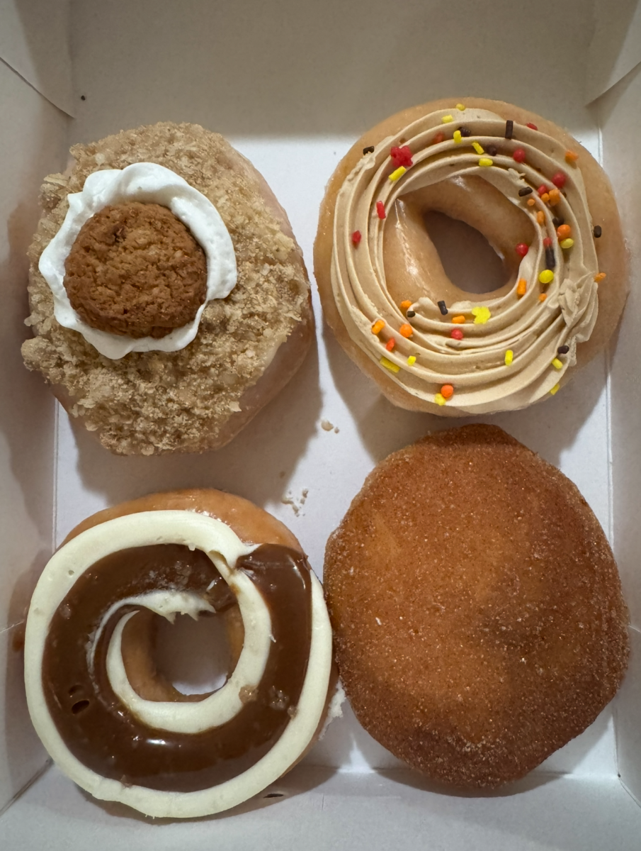 Opening of Krispy Kreme’s Golden Harvest Collection donuts that includes Oatmeal Creme Pie Doughnut at top right, Maple Buttercreme Doughnut at top left, Salted Caramel Cheesecake Doughnut at bottom right and Spice Apple Filled Doughnut at bottom left.