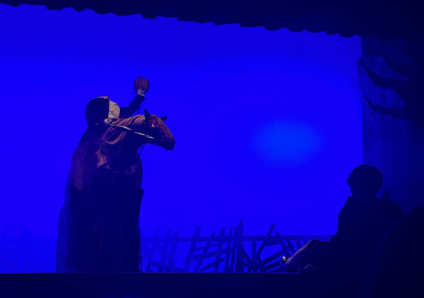 Ichabod quivers in fear as he meets his killer, the headless horseman. The pumpkin head used to murder Ichabod makes an appearance four times throughout the play.