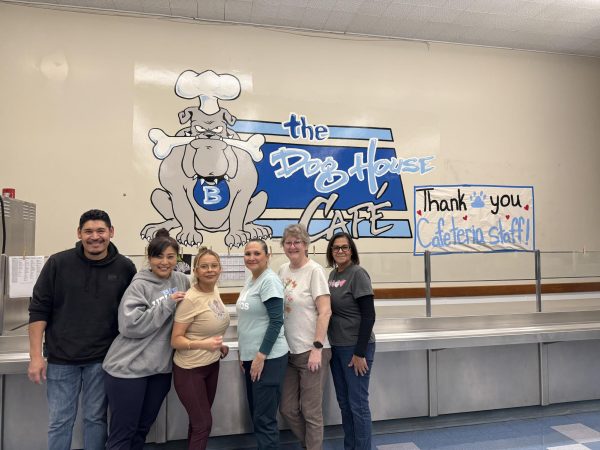 The cafeteria poses in front of the cafeteria mural. (From left to right) Ulises Hernandez Baltazar, Yukari Bell, Susanna Gomez, Sarah E Ortiz, Kimberly Hunter, Angie Marin