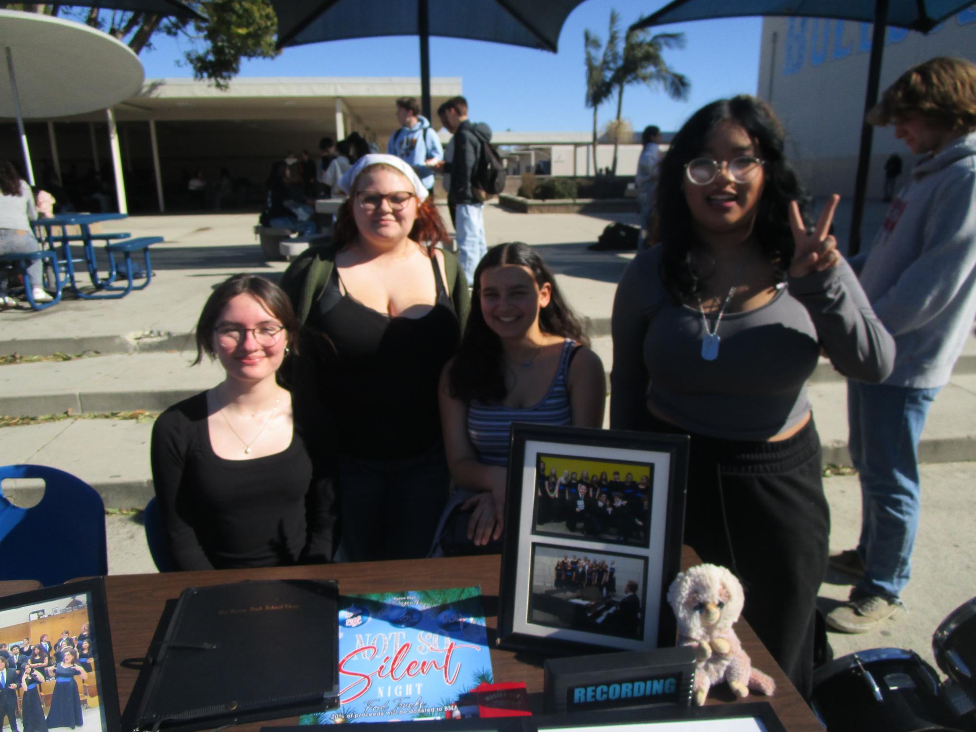 Representatives from Buena's choir class pose for a picture in front of their table.