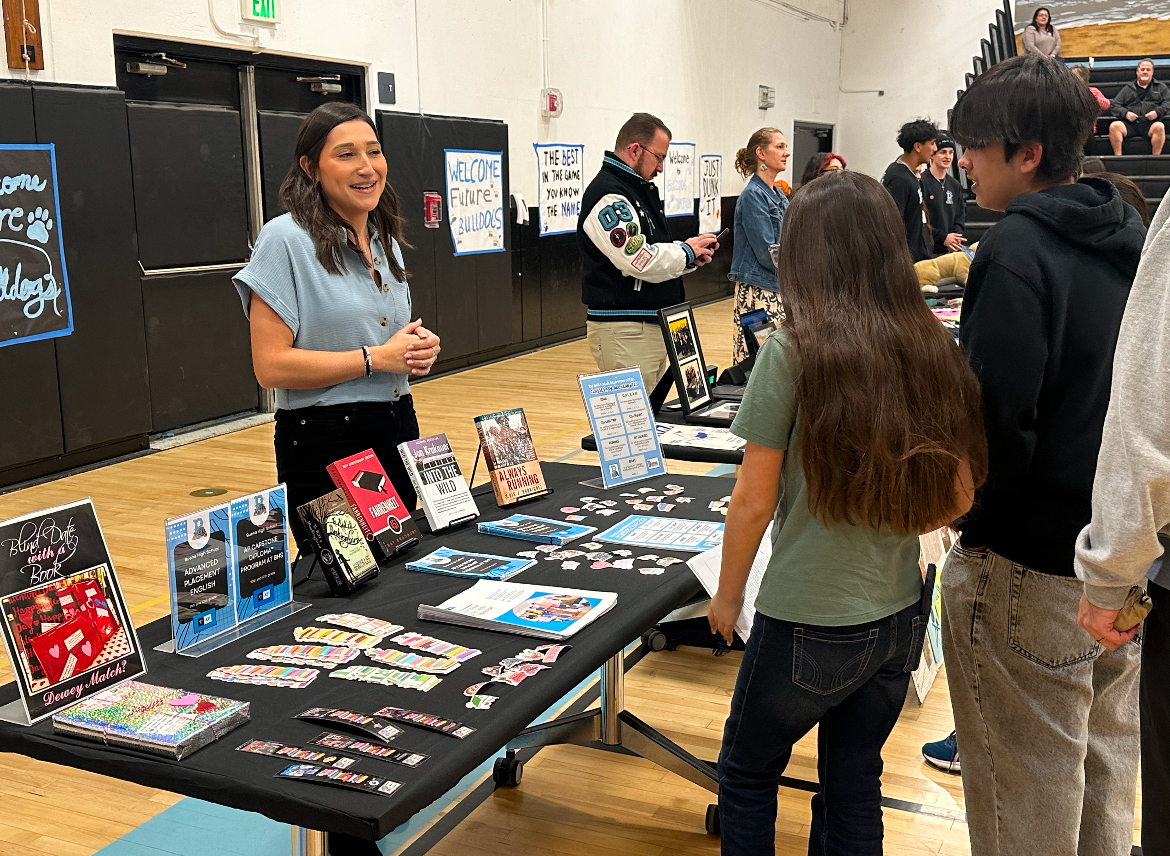 English teacher at Buena, Antoinette Perez, persuades students to take the AP English courses Buena offers, displaying an array of books from the program.