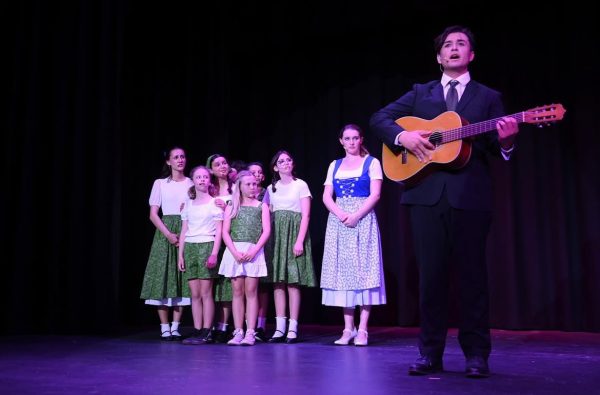 Captain Von Trapp (Nicolas Faught) singing with the rest of the Von Trapp family.