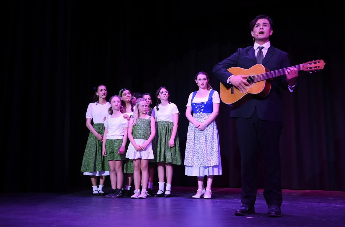 Captain Von Trapp (Nicolas Faught) singing with the rest of the Von Trapp family.
