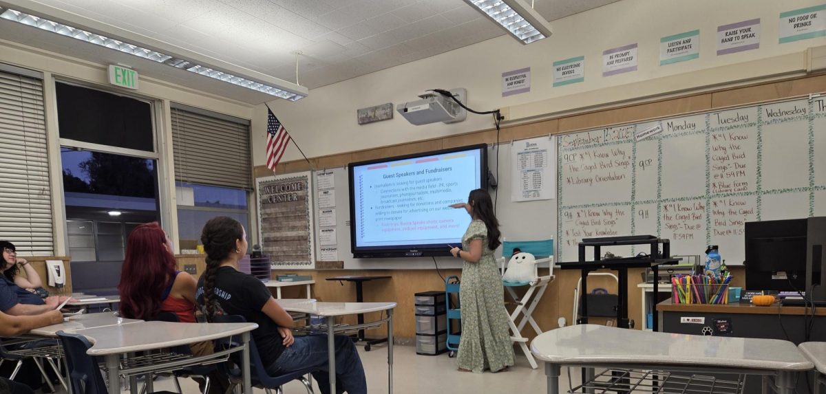 Parents listen to journalism advisor Ale Posada's presentation of the program