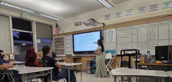 Parents listen to journalism advisor Ale Posada's presentation of the program