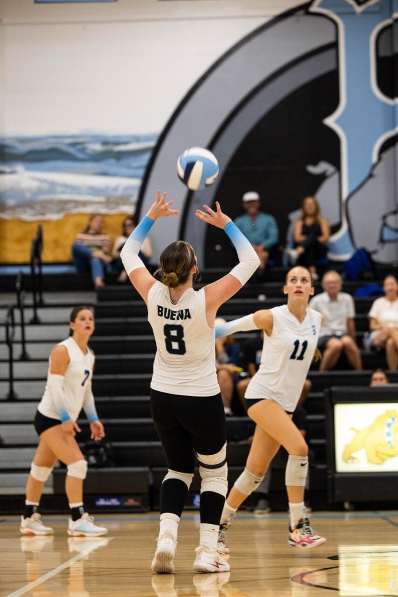 Junior setter and hitter Rilee Gosselin sets up a spike for Senior middle blocker Dylan Classen.