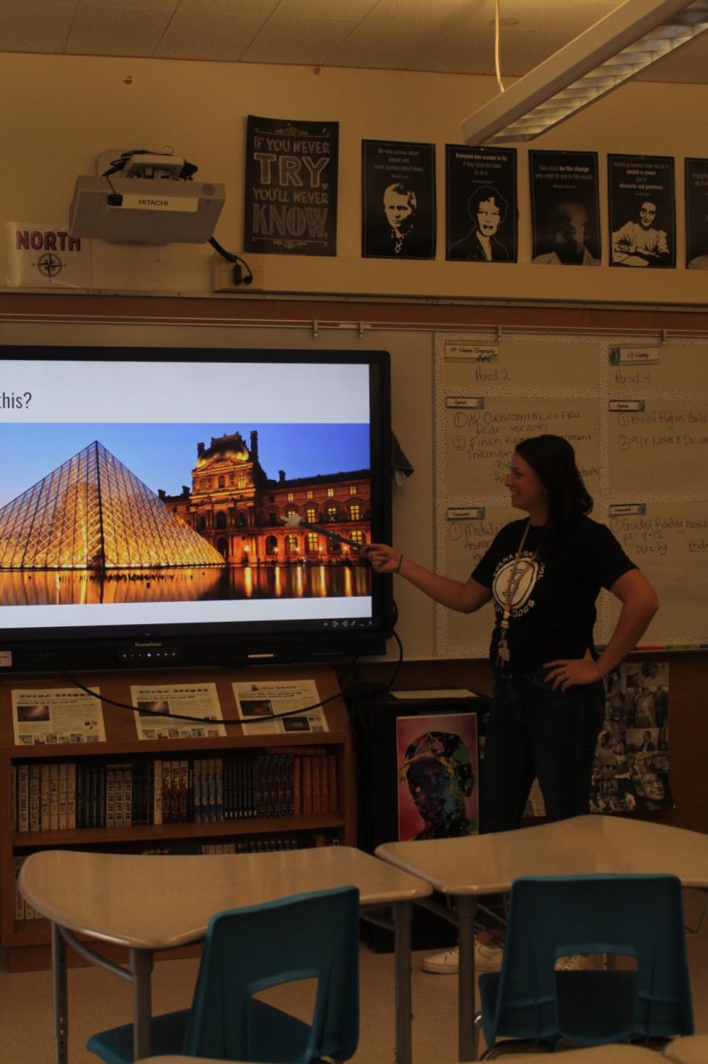 Ms. McCown going through a slideshow for APHG, featuring The Louvre Pyramid 