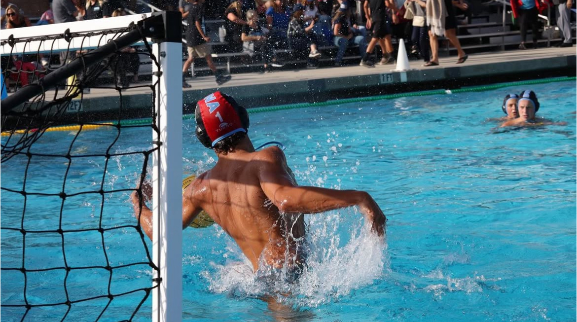 Senior and goalie Mack Munger comes up for the block, one of many he will make throughout the game