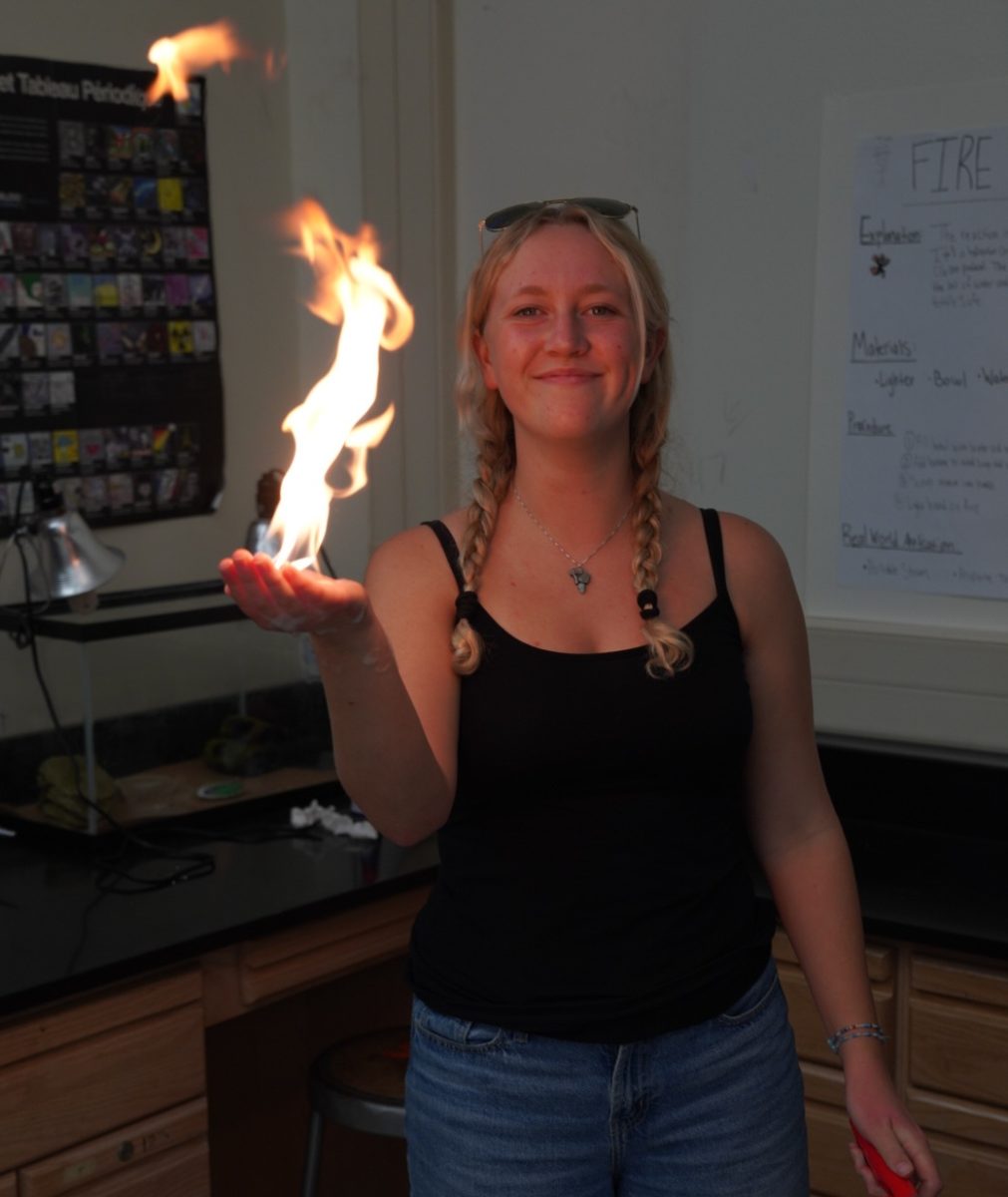 Junior Marlee Cattanach demonstrates her flaming hand experiment.