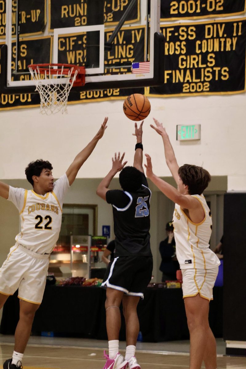 Junior and point guard, Caron Gervacio-Fiitzgerald attempts a layup.