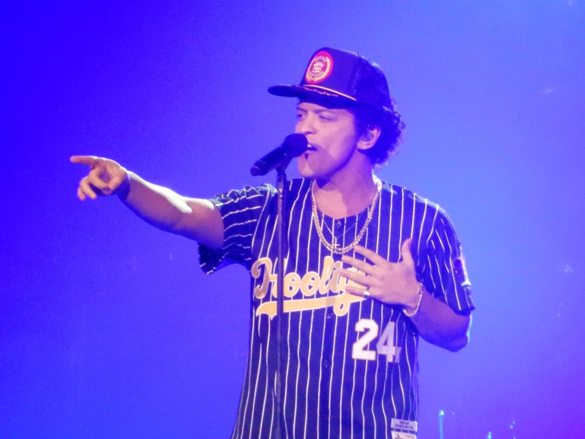 A picture of Bruno Mars singing during one of his concerts.
