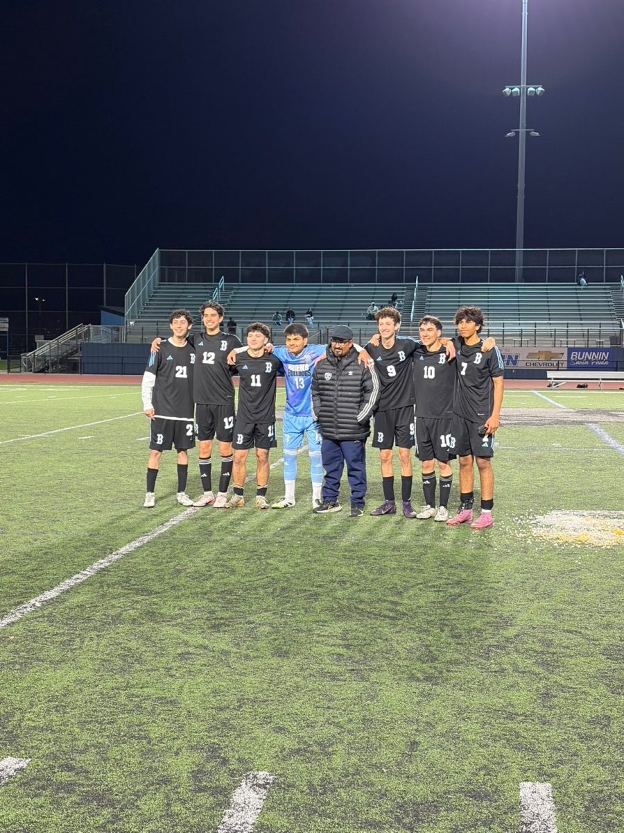 All of the boys varsity soccer players pose with Buena's head coach, Alfonso Rodriguez.