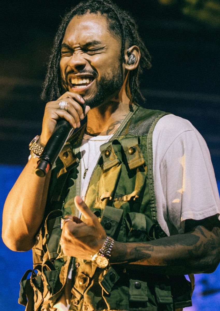 A photo of R&B artist Miguel singing to his beloved fans.