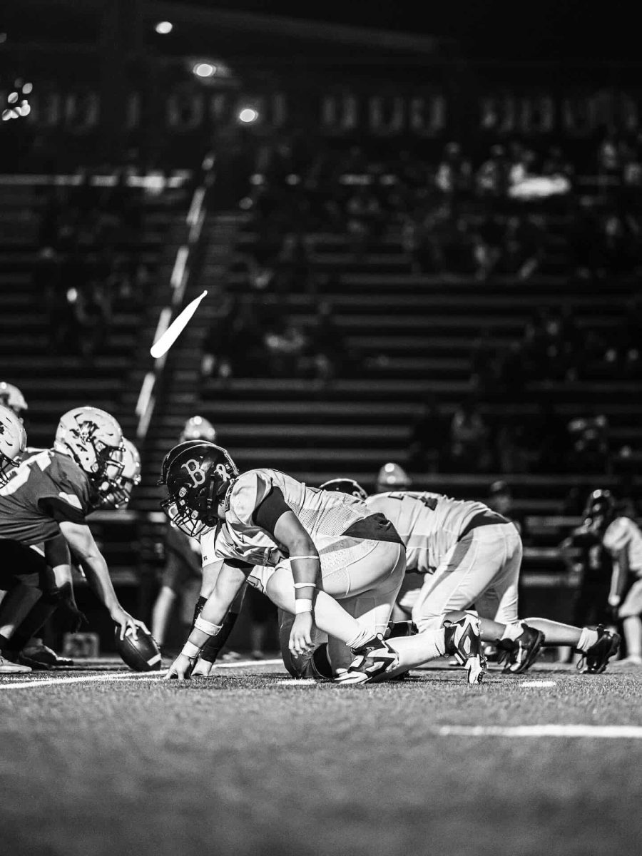 Nic Faught tackling an opponent on the football field.