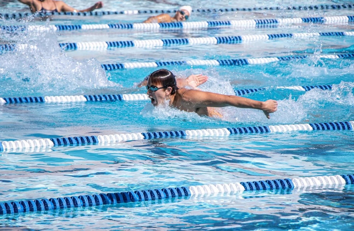 Swimmer River Davis performs one of the most challenging strokes, the butterfly, in a race on Buena swim team. 