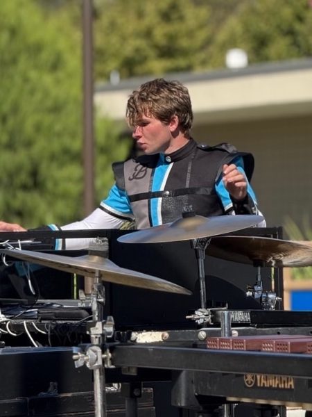 Coyner warming up on the synth before a marching band competition.