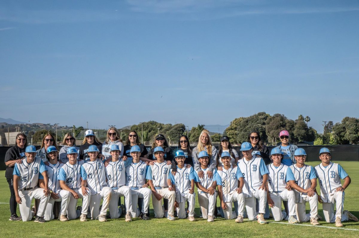Photo of some of the Seniors graduating posing with their moms. 