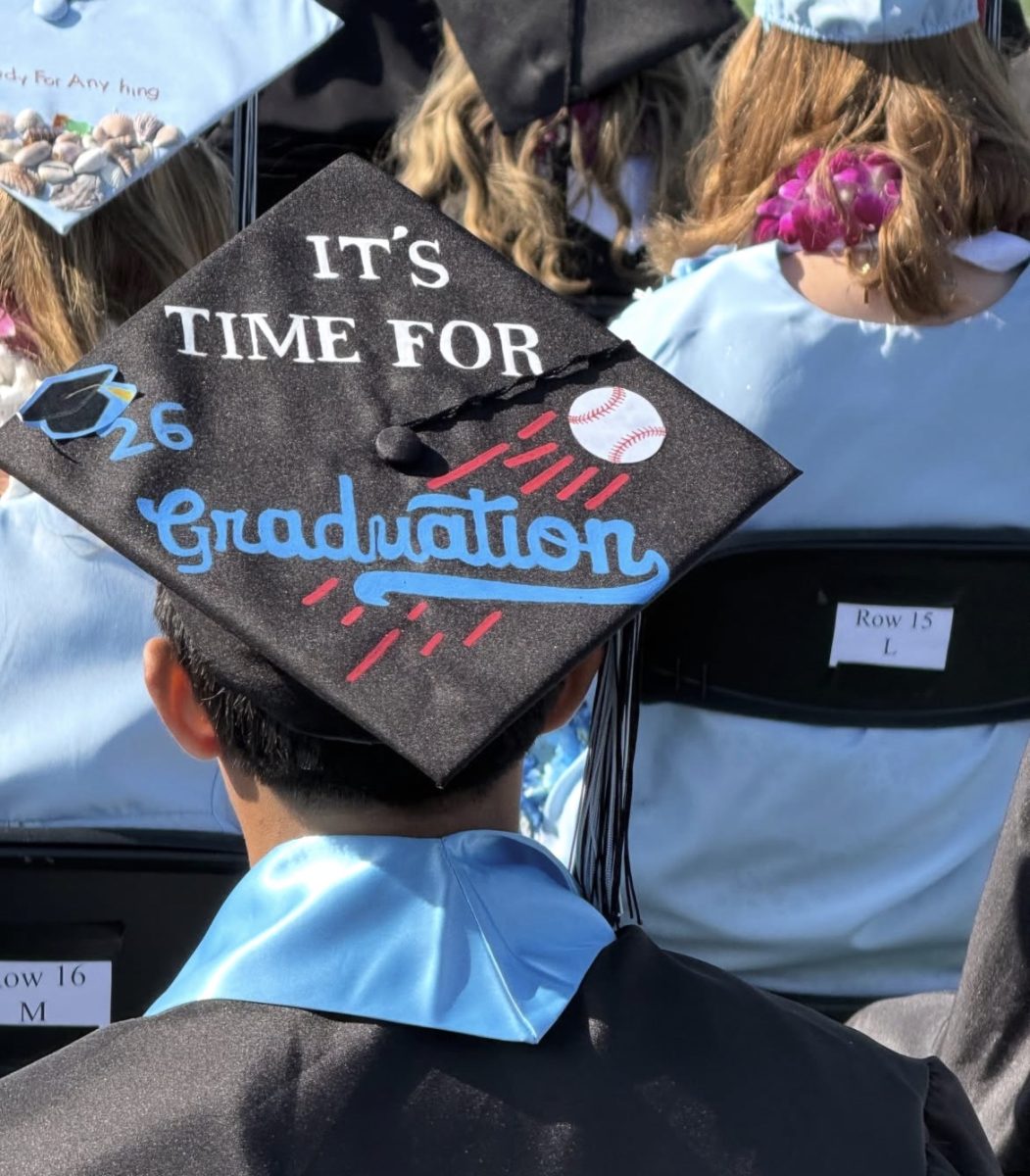 Seniors decorating their cap to showcase their personality at the Buena High Graduation.