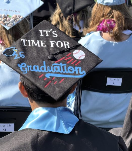 Seniors decorating their cap to showcase their personality at the Buena High Graduation.